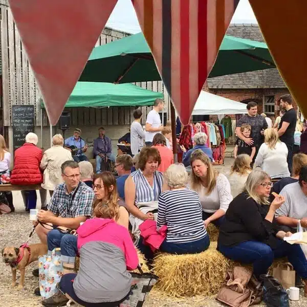 Customers relaxing outside the barns at Rode Hall Farmers' Market