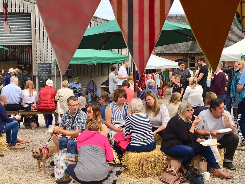 Customers relaxing outside the barns at Rode Hall Farmers' Market
