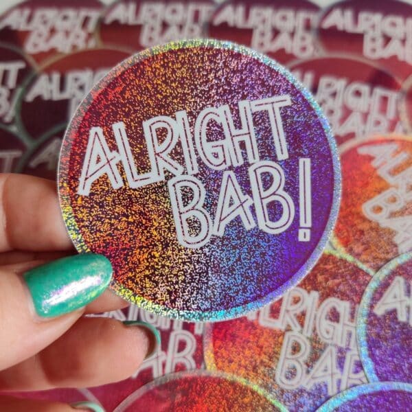 Circular Alright Bab Sticker with a glitter effect