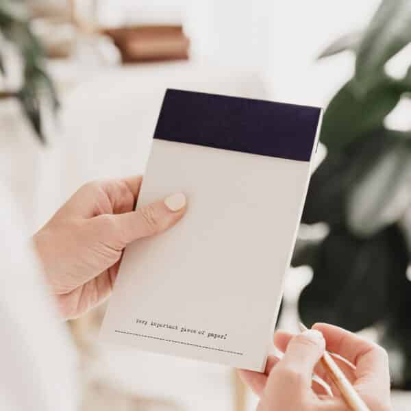 A tear off notepad with the words 'very important piece of paper' typed at the bottom of each page