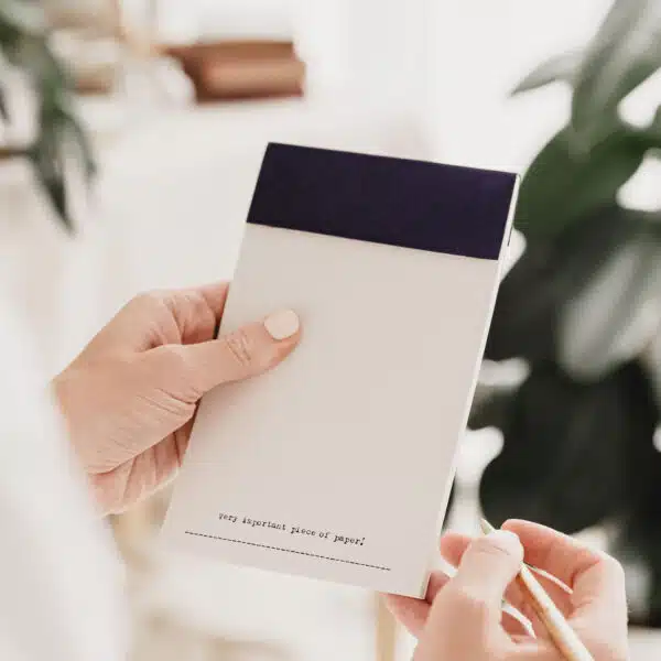 A tear off notepad with the words 'very important piece of paper' typed at the bottom of each page