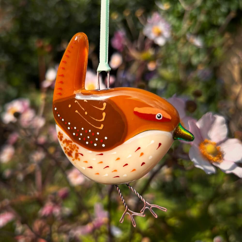 Handmade bird called a Jenny Wren that has been made out of glass and fused together in a kiln.