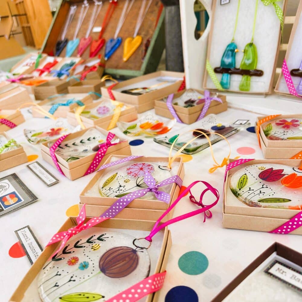A colourful photo showing a display of Sarah's work at the Treacle Market in Macclesfield.