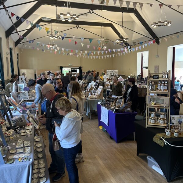 A community hall filled with tables and people browsing