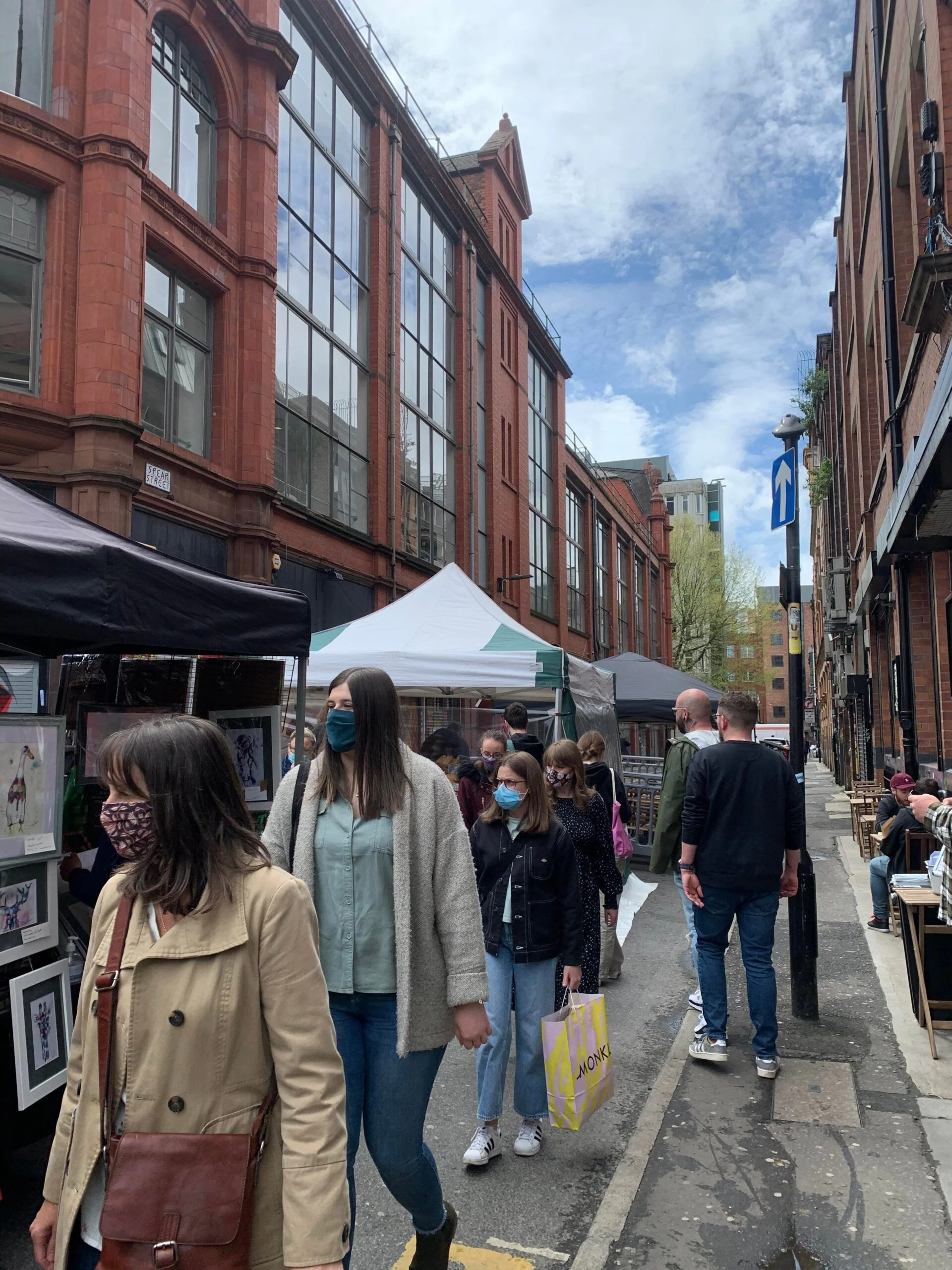 Customers walking through the Northern Quarters Makers Market in Manchester