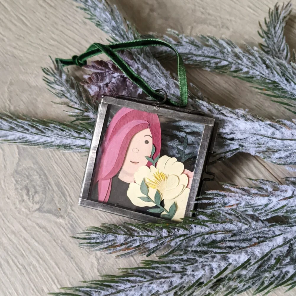 Bespoke paper portrait featuring a girl with pink hair holding flowers