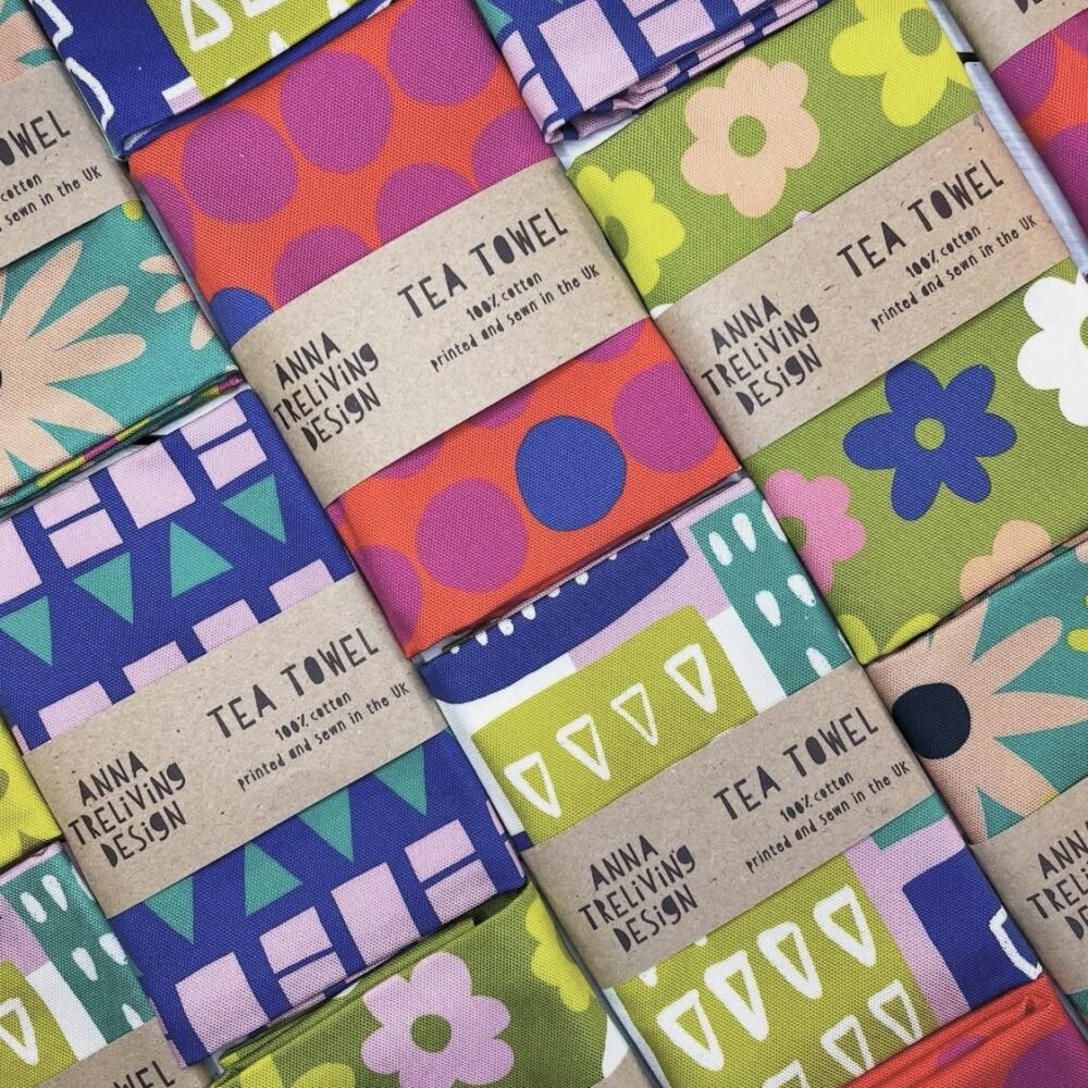 A selection of folded bright and colourful tea towels