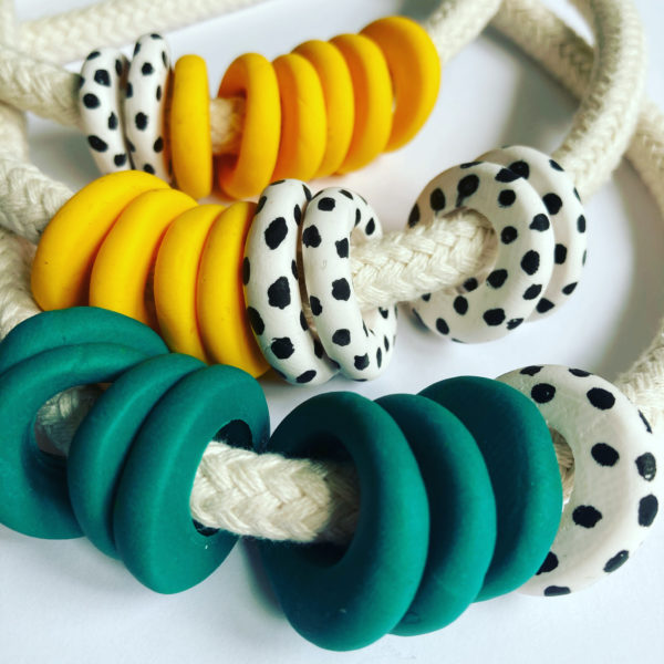 Loups, Rope necklace with handmade polymer clay beads in bright yellow, green and black and white spots.