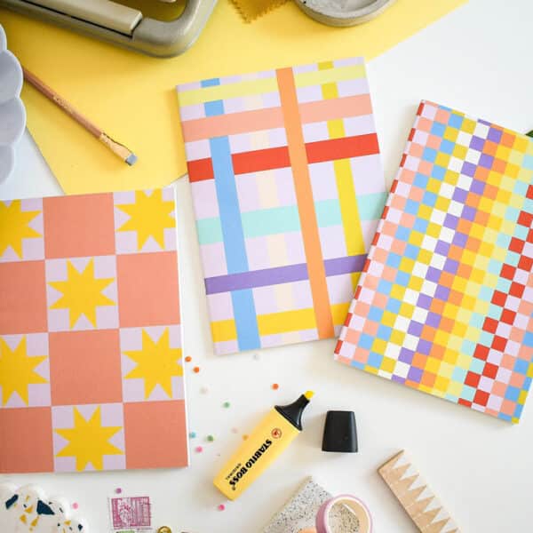 Set of 3 notebooks blank inside on a table