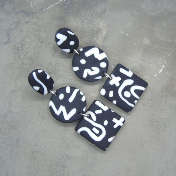 Monochrome black and white graffiti print polymer clay earrings inspired by the artist Keith Haring