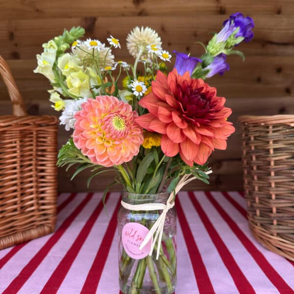 jar arrangement with beautiful locally grown dahlias by wild soul flowers