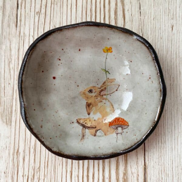 Trinket Dish with Rabbit and Mushroom Design, made using black clay and white glaze. By Laurel Tree Pottery