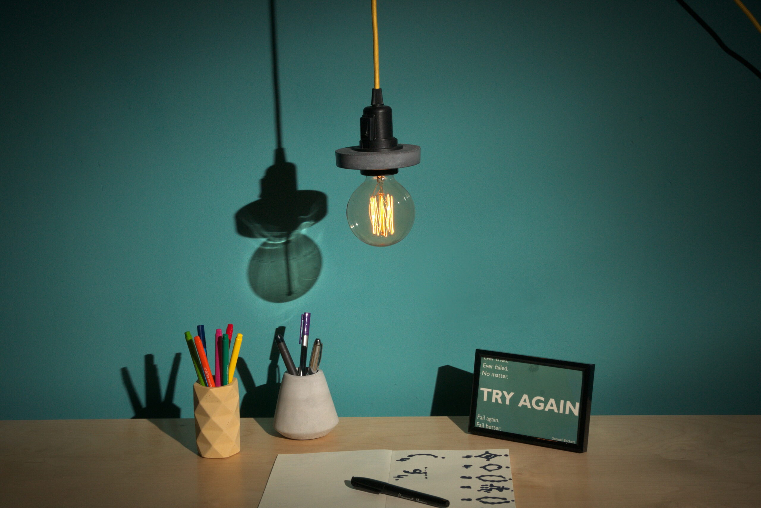 Mexish Made, Hanging Lamp, Yellow Pen Pot, Grey Pencil Pot on desk with Try Again photo