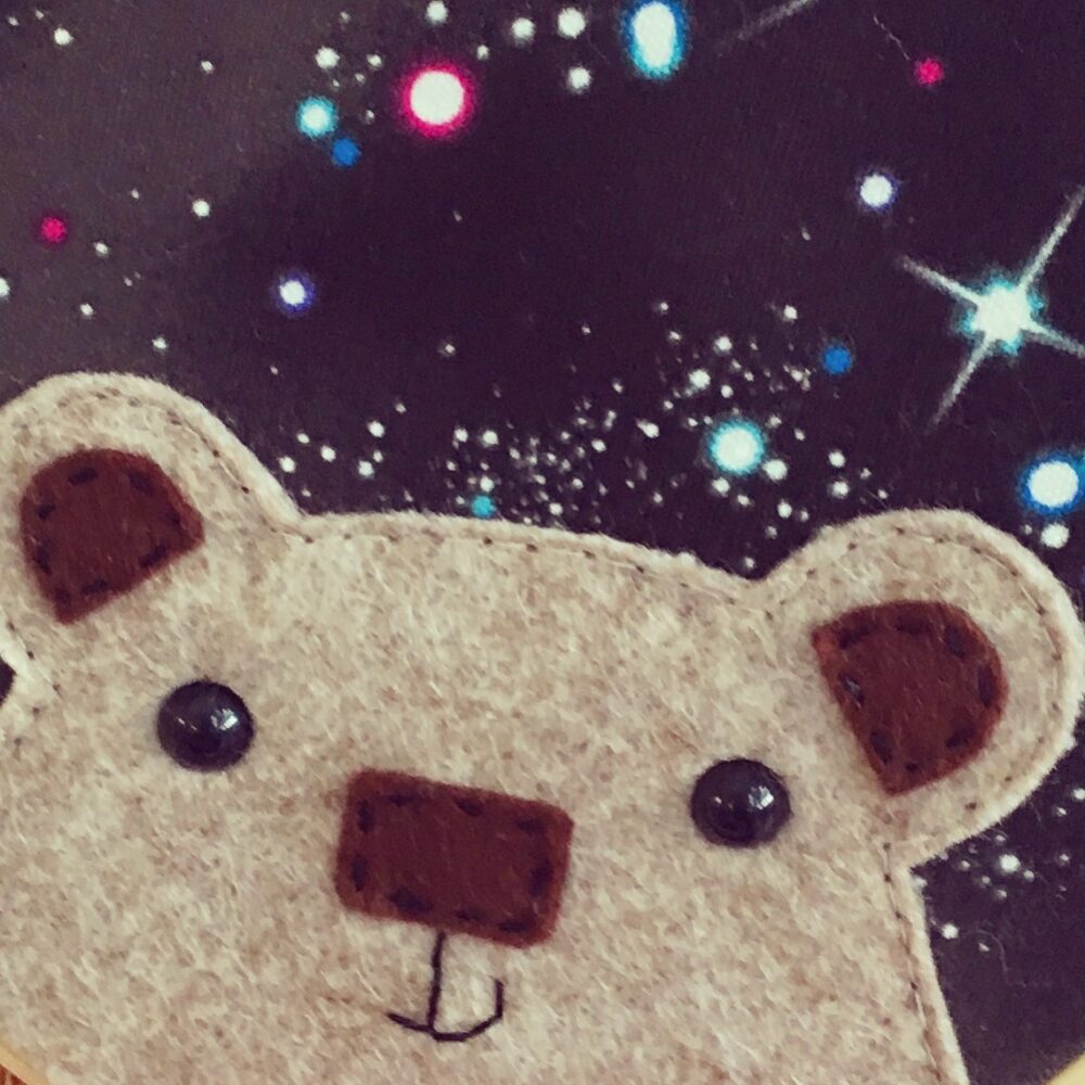 Detail of bear on embroidery hoop