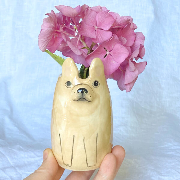 Dottir Studio Fawn French Bulldog Bud Vase being held on palm of hand with flowers