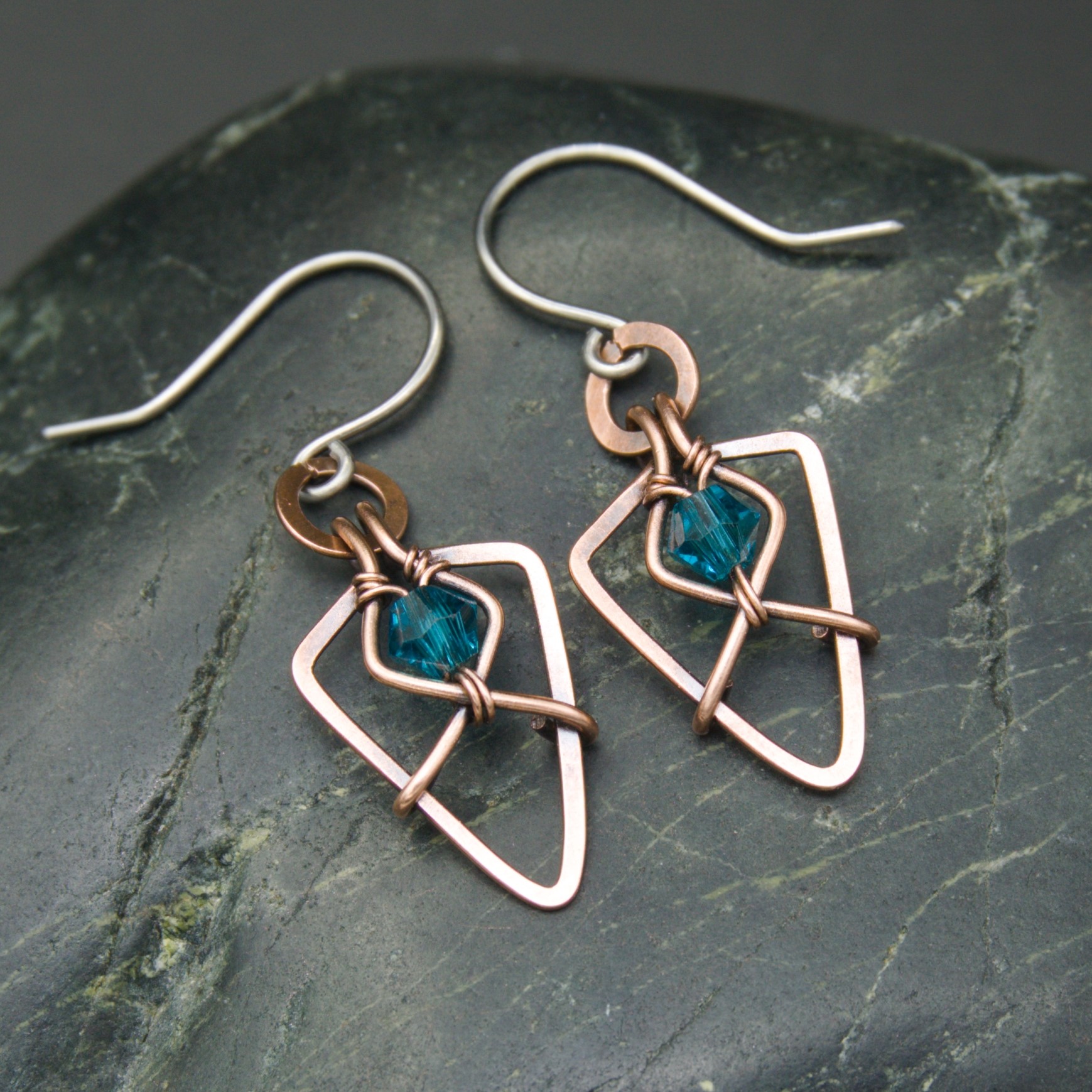 Oruki Design, Hammered copper and turquoise glass beads arrowhead earrings on grey stone