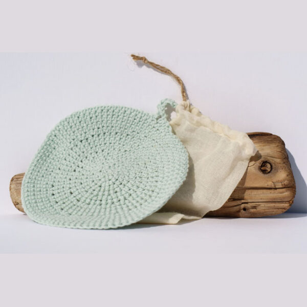 Gemma Thorpe Hand crochet face cloth with muslin bag sat on driftwood