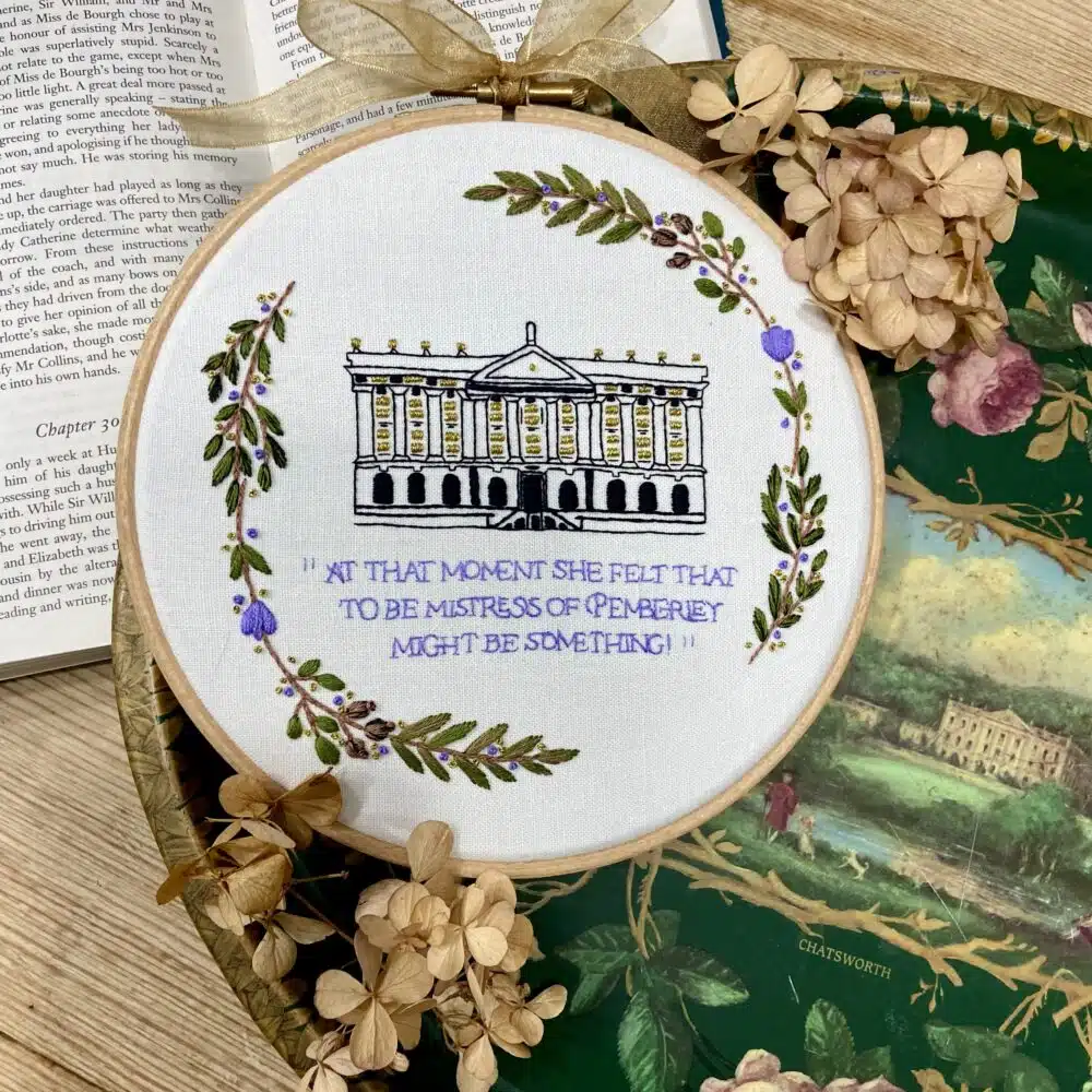 An embroidery kit featuring the quote “At this moment she felt that to be mistress of Pemberley might be something” alongside an embroidered depiction of Pemberley, inspired by Chatsworth House.