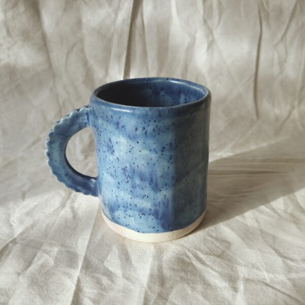 Victoria Ceramics, handmade stoneware mug with glazed in speckled blue and a scalloped handle