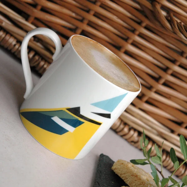 Twenty Birds Blue Tit mug with coffee and biscuits in front of a wicker basket