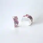Fine silver half hoops handmade earrings with purple resin flower details.