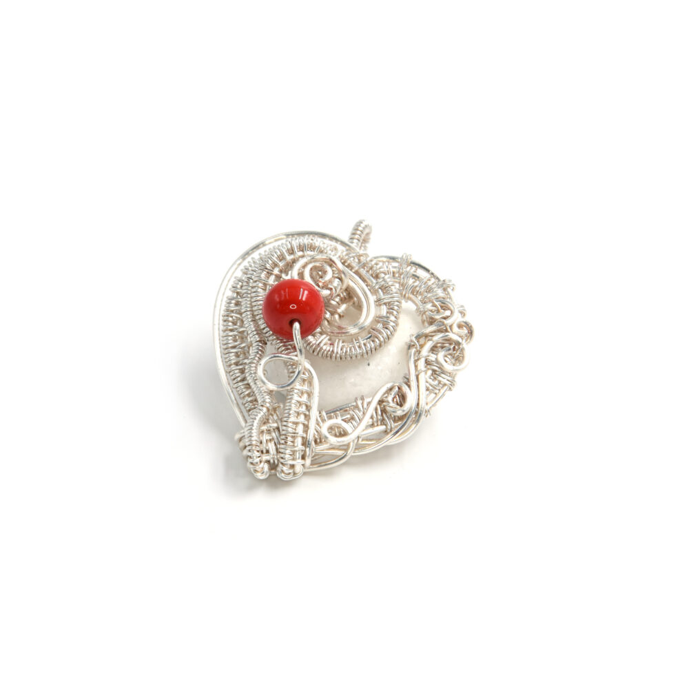 Heart shaped pendant in silver plated copper wire and an embeded coral bead
