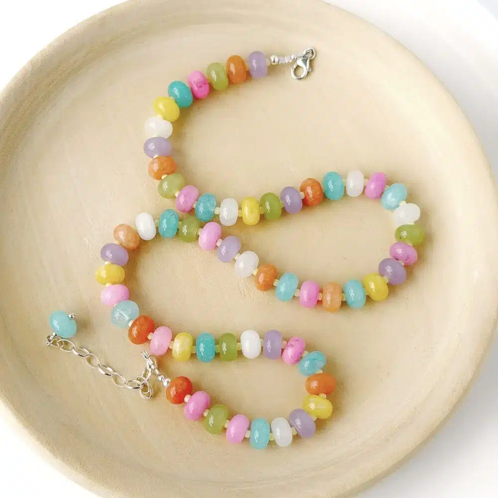 Hardy to Hudson multicoloured gemstone jasper beaded candy necklace with gold filled clasp and extender displayed on a wooden plate against a white background