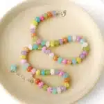 Hardy to Hudson multicoloured gemstone jasper beaded candy necklace with gold filled clasp and extender displayed on a wooden plate against a white background