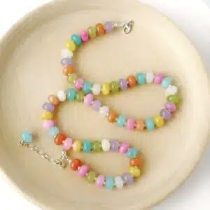 Hardy to Hudson multicoloured gemstone jasper beaded candy necklace with gold filled clasp and extender displayed on a wooden plate against a white background
