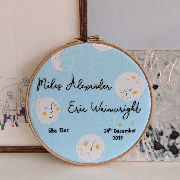 Little Light Stitchery new baby hoop. Moon face fabric with a babies name, weight and birth date hand embroidered