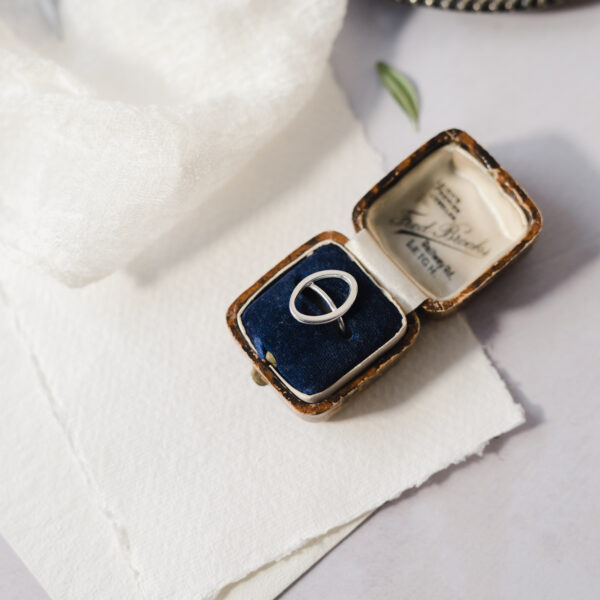 Upside Down Tree Studio, Oval open ring in a vintage ring box displayed on cream handmade paper