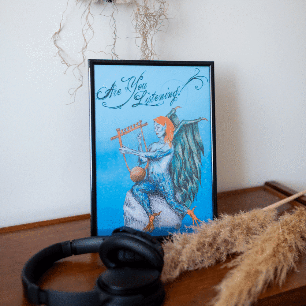 Art print displayed in a frame. The art shows a Siren or Harpy sitting on a rock playing a lyre. The text above the creature reads "Are You Listening?"