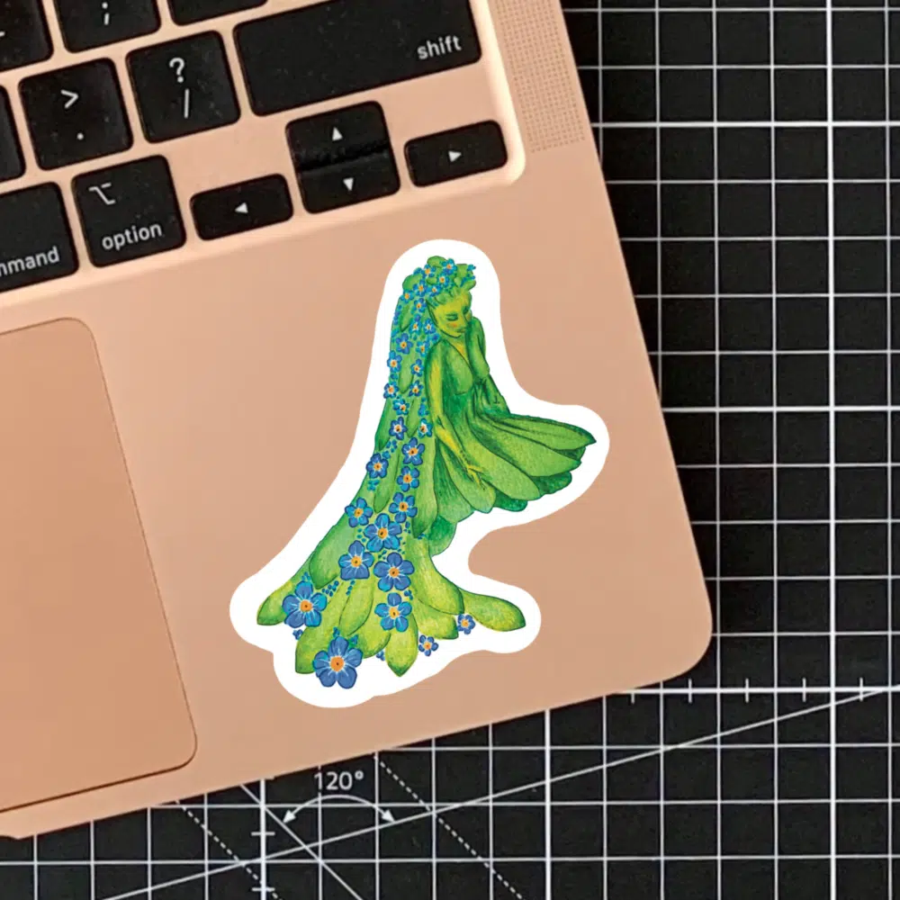 Sticker of a Forget-Me-Not fairy shown attached to a laptop.