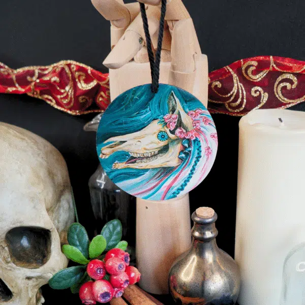 Circular wooden decoration showing an image of the Mari Lwyd.