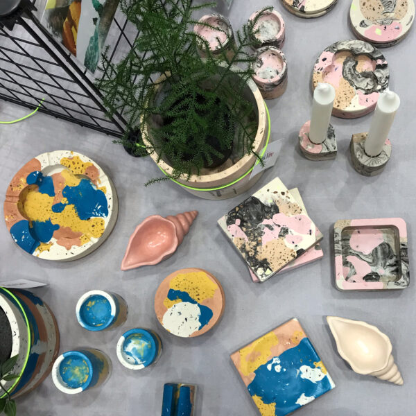 PinkVine, photo taken from directly above market stall set up, showing ashtrays, plant pots, coasters and candle holders.