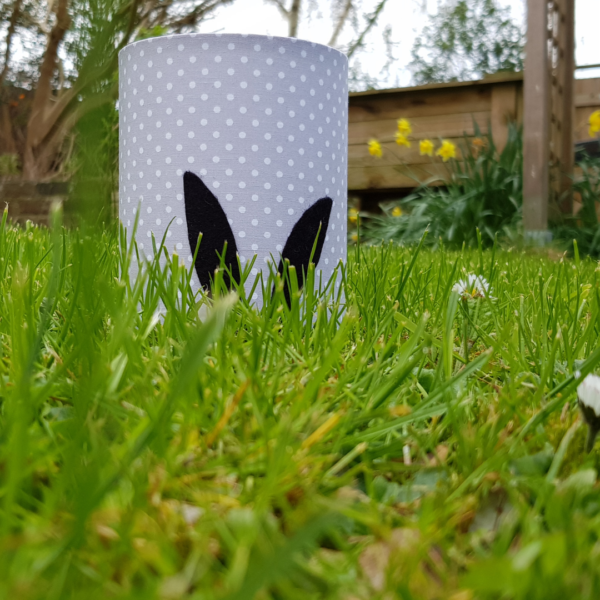 PeachTreePig - Black silhouette rabbit ear LED lantern on a pale grey and white spotty background. Displayed on a grassy lawn (© PeachTreePig)