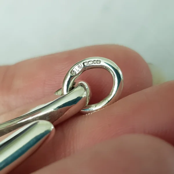 Full UK Hallmark (including Sarah Brown, PeachTreePig owner's maker's mark) struck by the London Assay Office on a sterling silver pendant jump ring