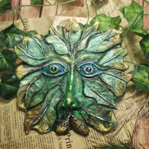 Bythecrookofmyhook clay greenman mask, hand painted on faded newspaper
