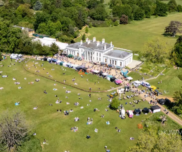 An drone shot of Hylands House with a market happening on the lawn.