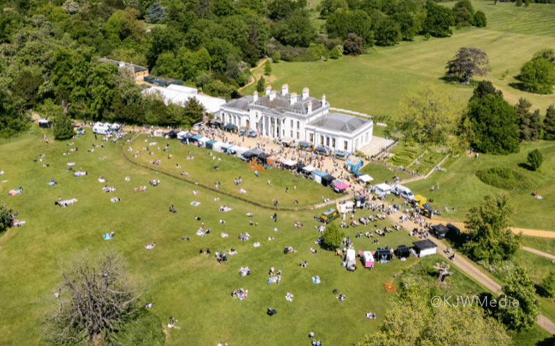An drone shot of Hylands House with a market happening on the lawn.