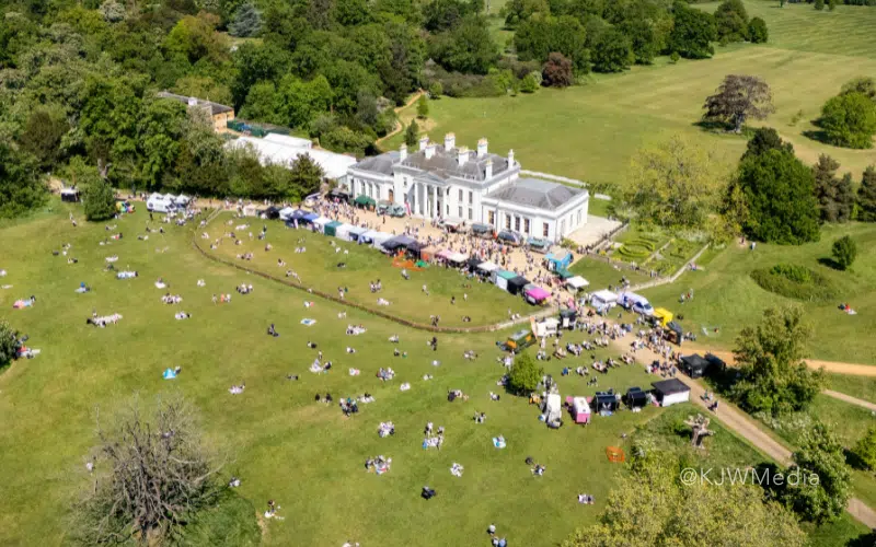 An drone shot of Hylands House with a market happening on the lawn.