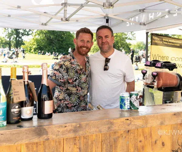 The English Vine booth guys smiling at the camera.