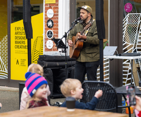 Live music being played by a guitarist at The Stables at Hylands Estate.