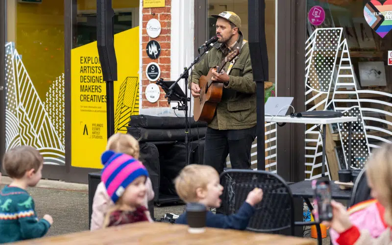 Live music being played by a guitarist at The Stables at Hylands Estate.