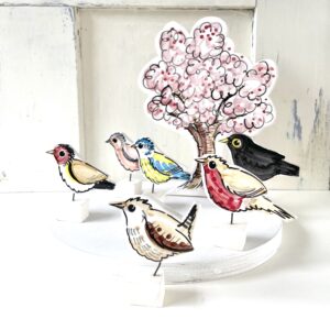 Louise Crookenden-Johnson garden birds, with pink blossom tree pottery ornaments