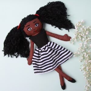 Amaris and chaya A black girl fabric doll wearing a white and black stripe dress