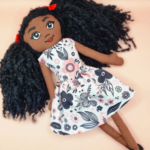 Amaris and chaya A black girl fabric doll wearing a pink and black dress