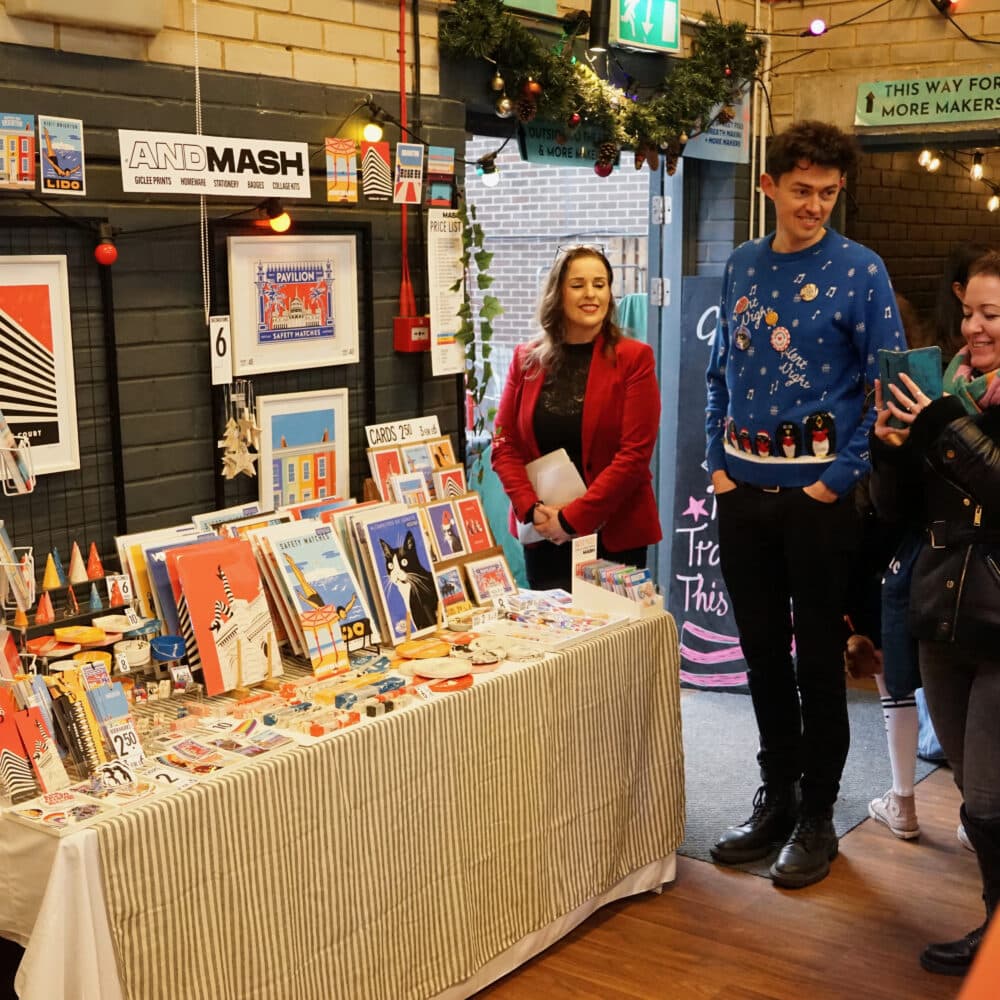 Visitors browsing a colourful stall of Brighton-inspired prints, cards and gifts at the Paper Daisy Festive Makers Fair at Wagner Hall.