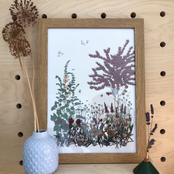 Photo of framed illustration of flowers and a tree