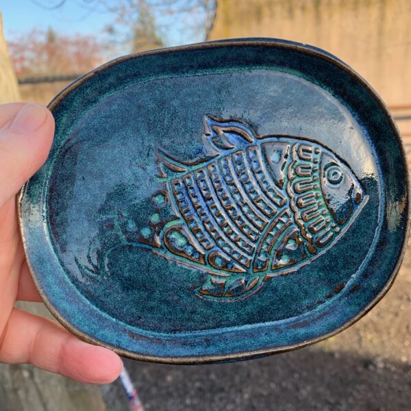 A small tapas dish textured with a fish pattern